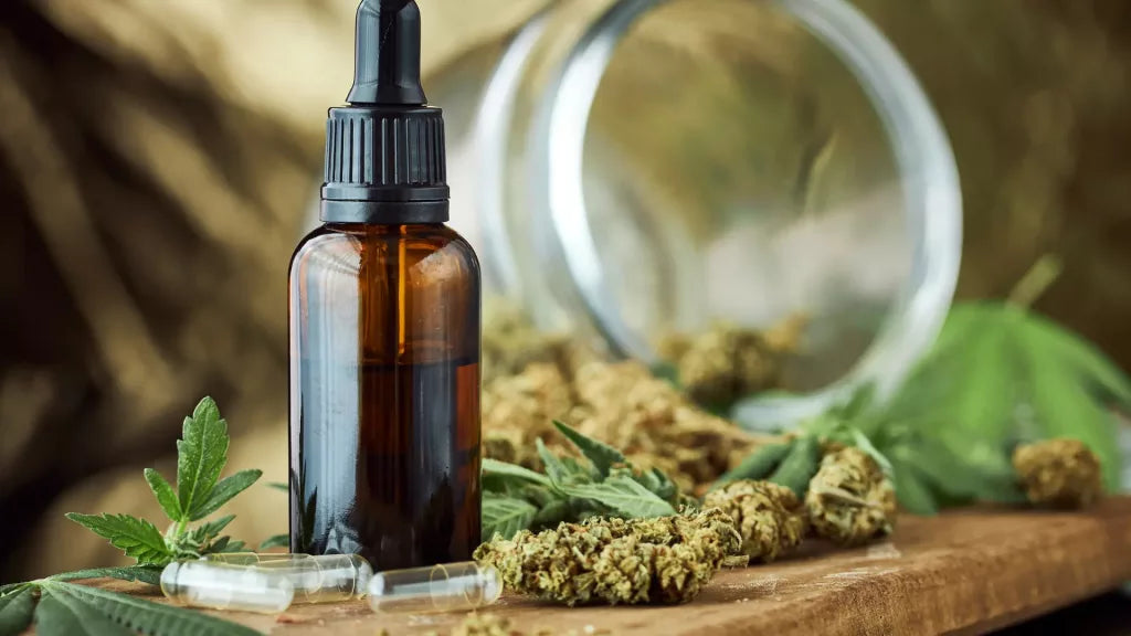 A Bottle of CBD Oil and Some of CBD Flower Buds and a CBD Flowers Jar