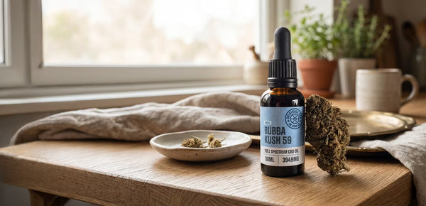 cbd oil with cbd flower on a wooden table by the window, with natural light.