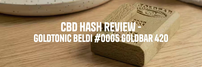 GoldTonic Beldi #0005 Goldbar 420 CBD Hash on a wooden tale showcasing its texture and appearance.