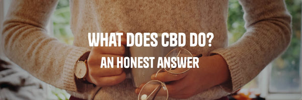 Person holding a warm cup and glasses suggesting calm and wellbeing - What Does CBD Do guide by Originals CBD
